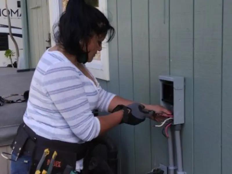 Licensed electrician wiring an exterior subpanel in Rome