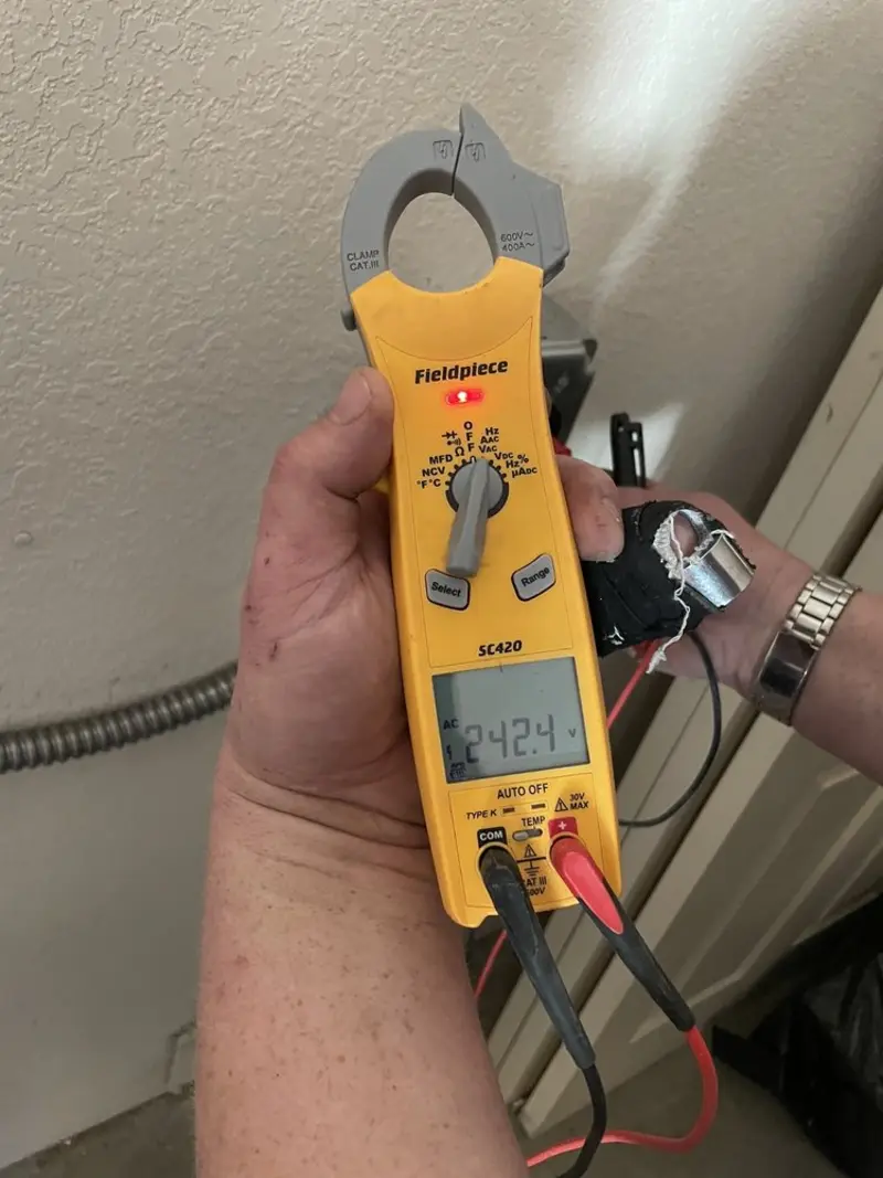Voltage testing with clamp meter during Recessed Lighting Installation in Rome